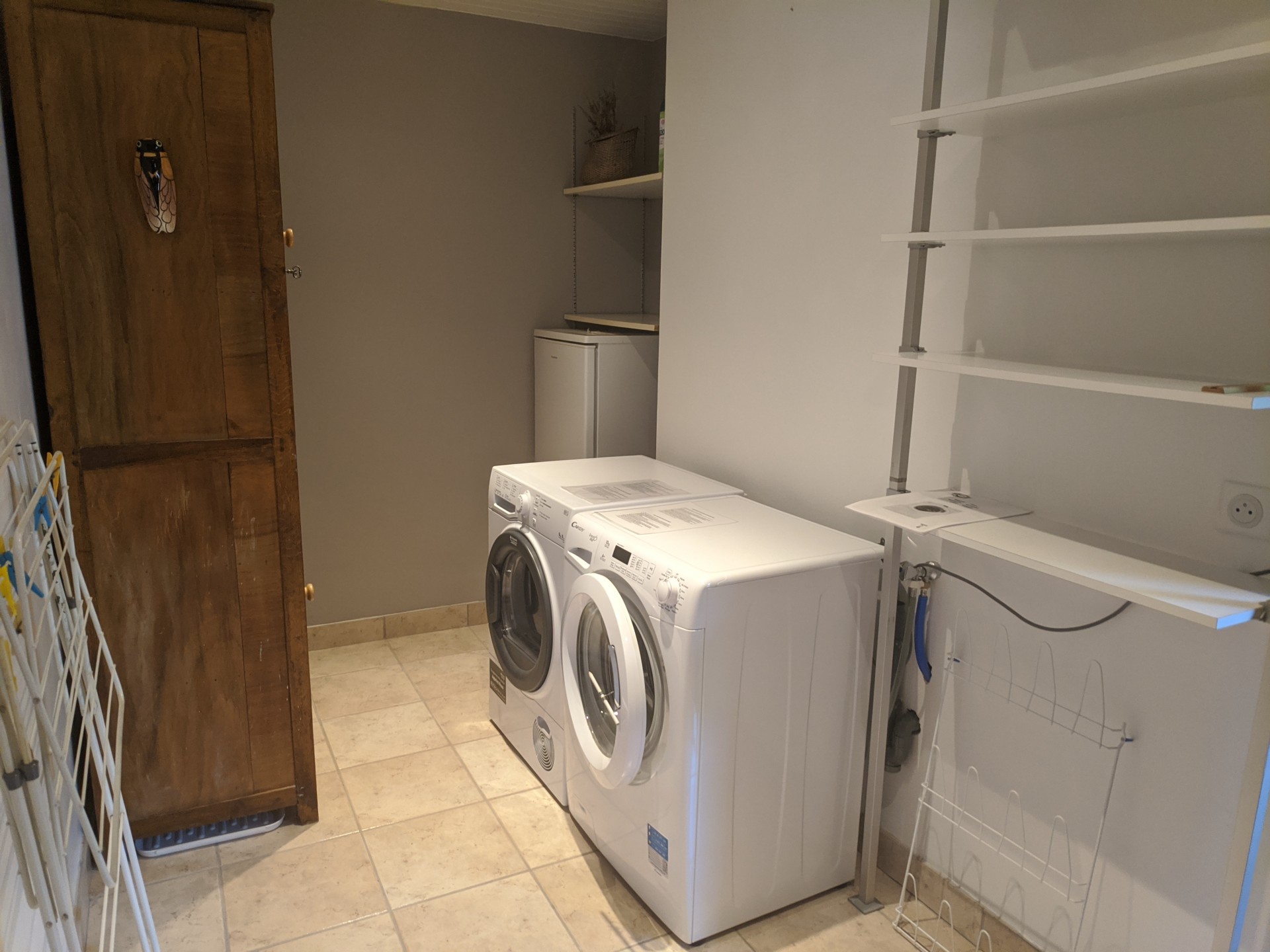 Laundry room and storage room with extra freezer-refrigerator